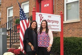 Two women standing outside Kinderprep building.